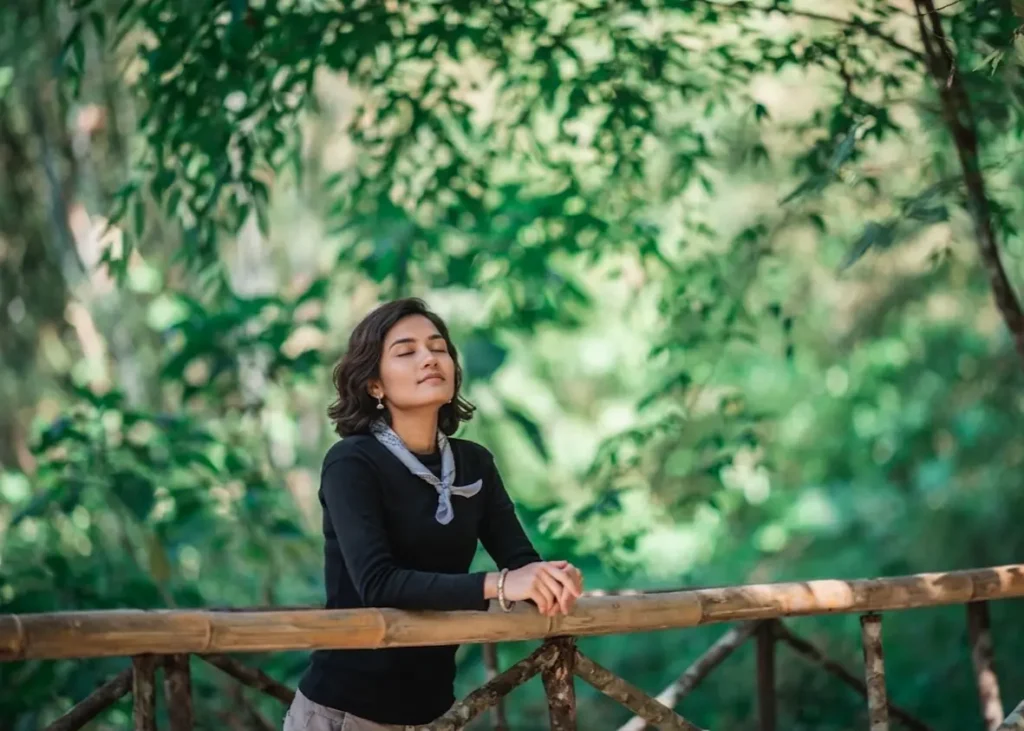 Online_therapy_woman_relaxing_outdoors_feeling_calm_and_stress_free