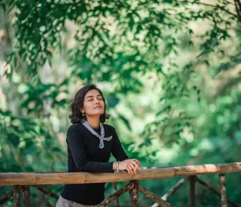 Online_therapy_woman_relaxing_outdoors_feeling_calm_and_stress_free